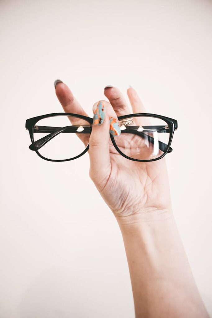 pexels-photo-1068866 Photo of Person Holding Eyeglasses
